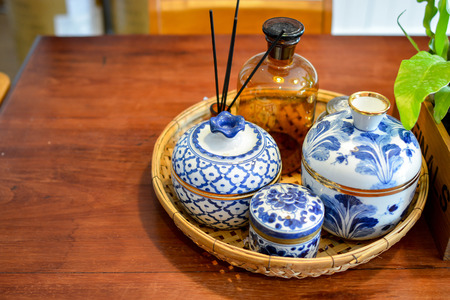 Thai traditional ceramic bowls with design painting texture on wood deskの写真素材