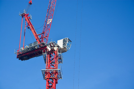 Red construction crane on clear blue skyの写真素材