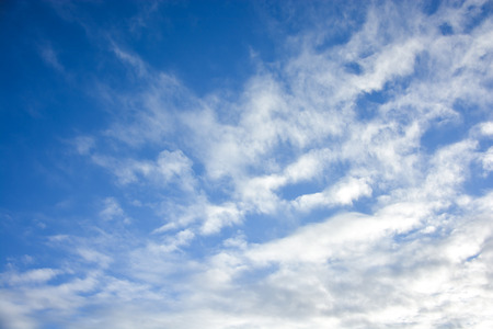 Blue sky with white cloud backgroundの写真素材