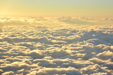 Aerial view of sky and clouds in the evening, taken from airplaneの写真素材