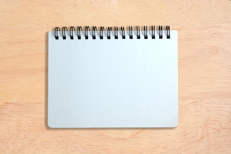 white page of notebook on wood texture backgroundの写真素材