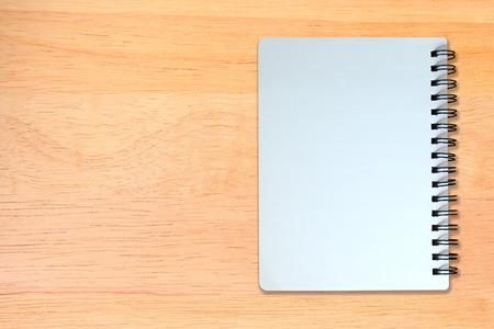 white page of notebook on wood texture backgroundの写真素材