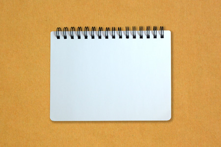 White page of notebook on yellow cardboard paperの写真素材