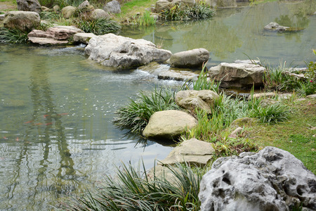 Small waterfall over rocks in Chinese gardenの写真素材