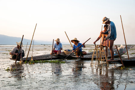 INLE LAKE, MYANMAR-APRIL 11, 2012 : Fishermen catch the fishes by their traditional method in Inle lake. They are Intha tribe, the Lake dwellers, unique for their leg rowing.のeditorial素材
