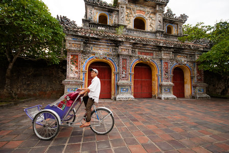 HUE VIETNAM  OCTOBER 23 2012 : unidentified Pedicab wait for tourist in front of the entrance of...