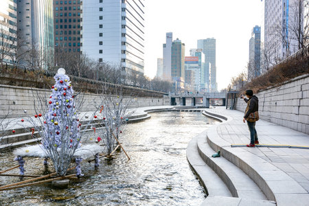SEOUL, SOUTH KOREA - OCTOBER 3, 2014 : People at Cheonggyecheon stream in winter. The stream is a modern public recreation space in downtown Seoul, South Korea.のeditorial素材