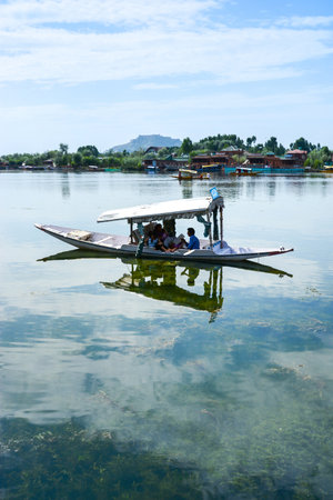 SRINAGAR, INDIA - JULY 11, 2014 : Lifestyle in Dal lake, local people use Shikara, a small boat for transportation in Dal lake of Srinagar, Jammu and Kashmir state, Indiaのeditorial素材