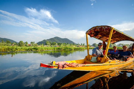 SRINAGAR, INDIA - JULY 11, 2014 : Lifestyle in Dal lake, people who come here use Shikara, a small boat for tourism in the lake of Srinagar, Jammu and Kashmir state, Indiaのeditorial素材