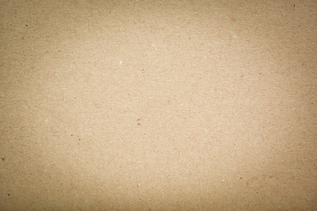 closeup detail of old brown paper texture background with light in centerの写真素材