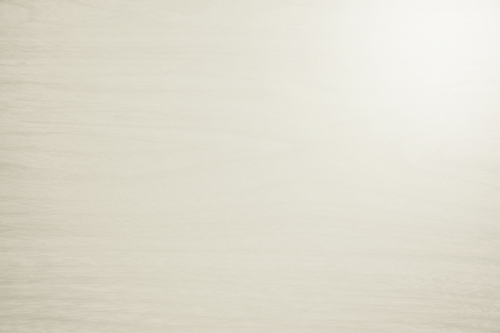 closeup detail of abstract light beige wood texture background with light on top leftの写真素材