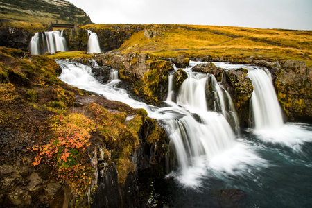 Beautiful waterfall landscape near Kirkjufell mountain in the Snaefellsnes Peninsula, natural...