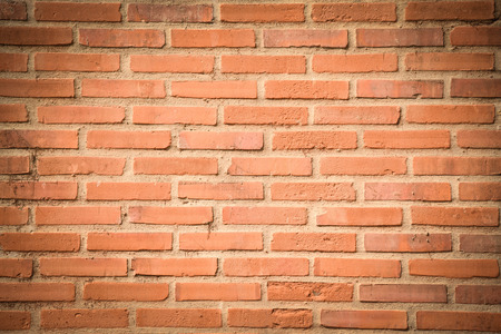 Brown-orange grunge brick wall texture or dirty surface pattern for background and backdrop, architectural element in urban concept, retro or vintage styleの写真素材