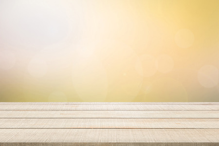 Beige wood table top panel on yellow blurred background, use for display or montage products for advertisement in summer conceptの写真素材