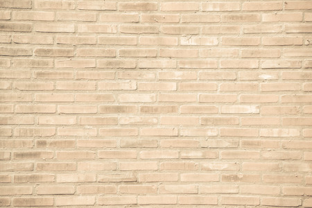 Beige-brown grunge brick wall texture or dirty surface pattern for background and backdrop, architectural element in urban concept, retro or vintage styleの写真素材