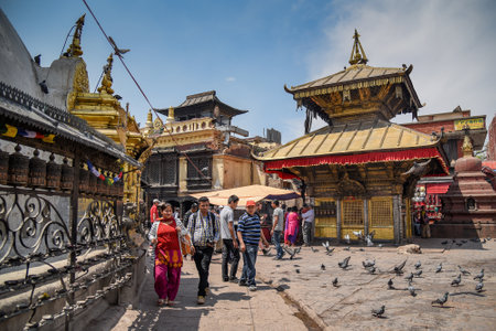 KATHMANDU, NEPAL - APRIL 7, 2016 : People walk around Stupa in Swayambhunath (monkey temple), one of famous landmarks in Kathmandu valley, Nepalのeditorial素材