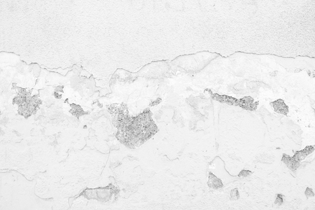 closeup surface detail of old white crack grunge concrete wall - use for background in architecture, structure or building conceptsの写真素材