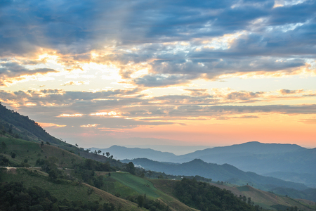layers of mountain range and beautiful sunset sky, natural environment backgroundの写真素材
