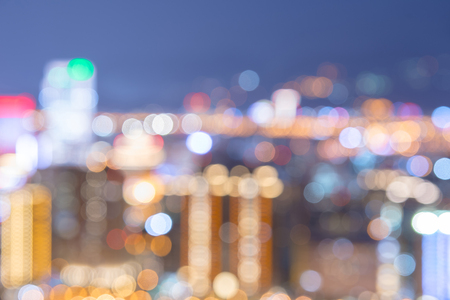 Abstract colorful blur bokeh night city life, blurry view of urban street lights for background or backdrop in modern lifestyle conceptsの写真素材