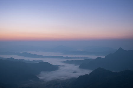 beautiful mist on the hill during sunrise, beautiful mountain range and colorful sky landscape in winter season, nature background conceptsの写真素材