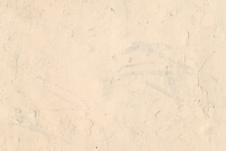 close up detail of old beige brown plaster wall, abstract rough surface for background, backdrop or design element in architectural material conceptsの写真素材