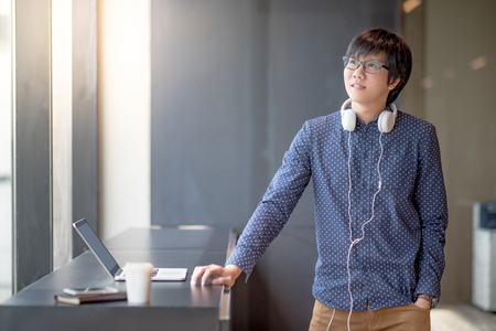 Young Asian man working with his laptop computer. high school or university college student, educational conceptの写真素材