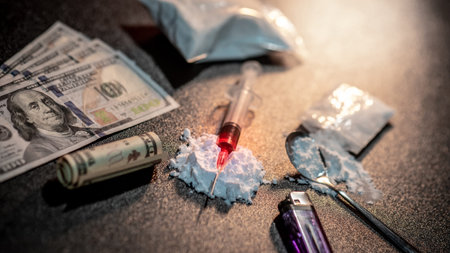 Drug injection syringe on heroin powder. Spoon with cigarette lighter for heroin cooking and money...