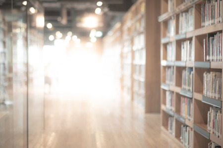 Abstract blurred public library interior space. blurry room with bookshelves by defocused effect. use for background or backdrop in business or education conceptsの写真素材