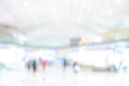 Abstract blur airport terminal. Blurred hall interior in transportation building. Defocused effect background or backdrop for travel industry concept.の写真素材