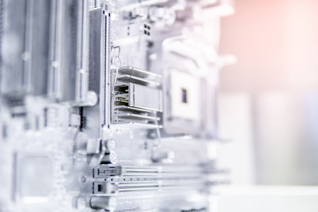 Close up of silver computer mainboard or metallic electronic circuit board. Use for background or backdrop in futuristic hardware technology conceptの写真素材