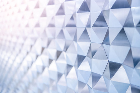 Close up detail of abstract modern metallic triangular wall pattern. Silver triangle geometric art...