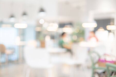 Abstract blurred restaurant background. Blurry cafe or coffee shop with dining tables, chairs and other decorations. Blur backdrop for design element. Food and beverage concept.の写真素材