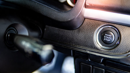 Car engine start stop button or power ignition button on modern car console. Auto transport...