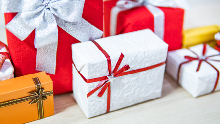 Christmas present concept. Group of colorful gift box with ribbon on wooden table. Giving and...