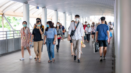 THAILAND, BANGKOK - MARCH 16, 2020 : Crowded people wearing face mask for protect Coronavirus (COVID-19) outbreak and PM2.5 air pollution walking on urban walkway in rush hour.のeditorial素材
