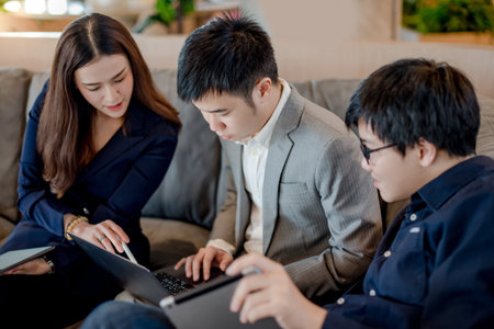 Business meeting and teamwork concept. Asian colleagues discussing about project data report using...