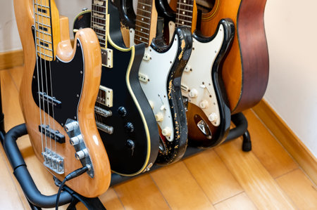 Set of electric guitars, electric bass and acoustic guitar on stand in music recording studio. Musical string instrumentの写真素材