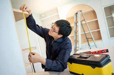 Home renovation or House remodeling concept. Asian male furniture assembler or Interior construction...
