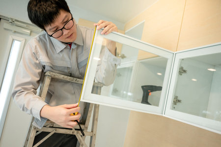 Home renovation or House remodeling concept. Asian male furniture assembler or Interior construction...