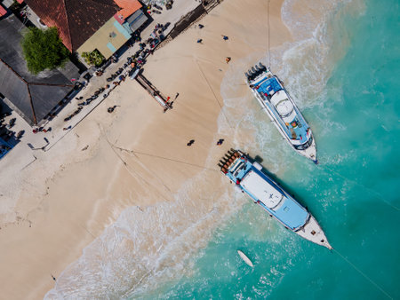 Aerial shoreline view of Jungutbatu beach at Nusa Lembongan with tourist speedboat anchored. One of travel destinations close to Bali island, Indonesia.の写真素材
