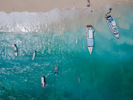 Aerial shoreline view of Jungutbatu beach at Nusa Lembongan with tourist speedboat anchored. One of travel destinations close to Bali island, Indonesia.の写真素材