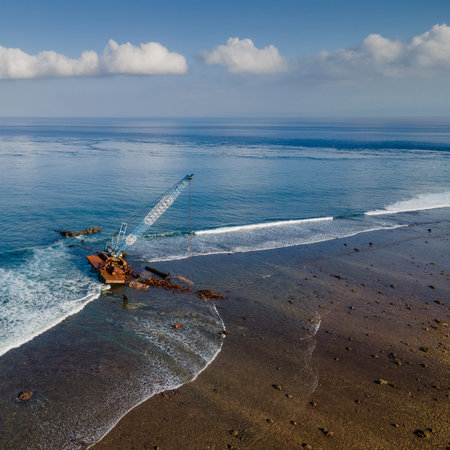 Aerial view of abandoned construction crane over the sea near beach of Nusa Lembongan, an island close to Bali, Indonesia.の写真素材
