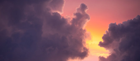 Sunset sky clouds at dusk with pink, yellow and purple sunlight after sundown. Romantic twilight sky in the evening of summer season. Use for background in nature conceptの写真素材