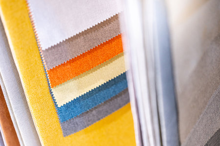 Set of colorful fabric swatch material collection. Various color and texture sample fabric pieces at home interior decoration store. Textile industry for furniture finishing or clothing designの写真素材