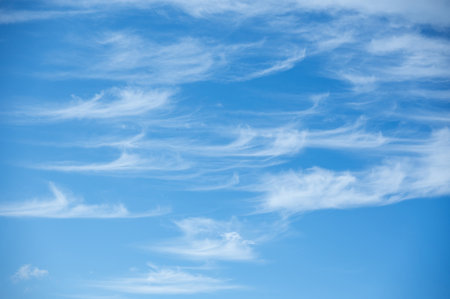 Soft white cirrus clouds against the blue sky on a sunny day. Empty space use for background or backdrop in nature conceptの写真素材