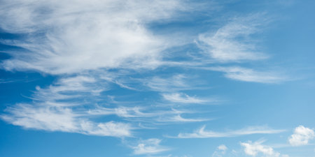 Soft white cirrus clouds against the blue sky on a sunny day. Empty space use for background or backdrop in nature conceptの写真素材