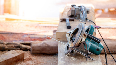 Electric circular saw on timber stack in a wood workshop. Work tool for carpentry used for cutting wooden plank or board. Lumber industry conceptの写真素材