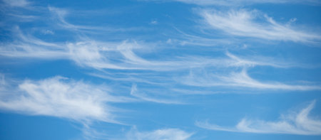 Soft white cirrus clouds against the blue sky on a sunny day. Empty space use for background or backdrop in nature conceptの写真素材