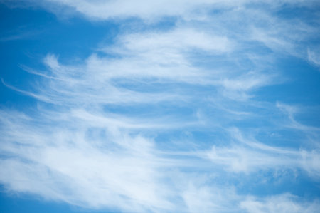 Soft white cirrus clouds against the blue sky on a sunny day. Empty space use for background or backdrop in nature conceptの写真素材