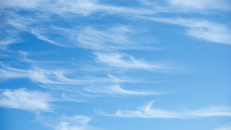 Soft white cirrus clouds against the blue sky on a sunny day. Empty space use for background or backdrop in nature conceptの写真素材